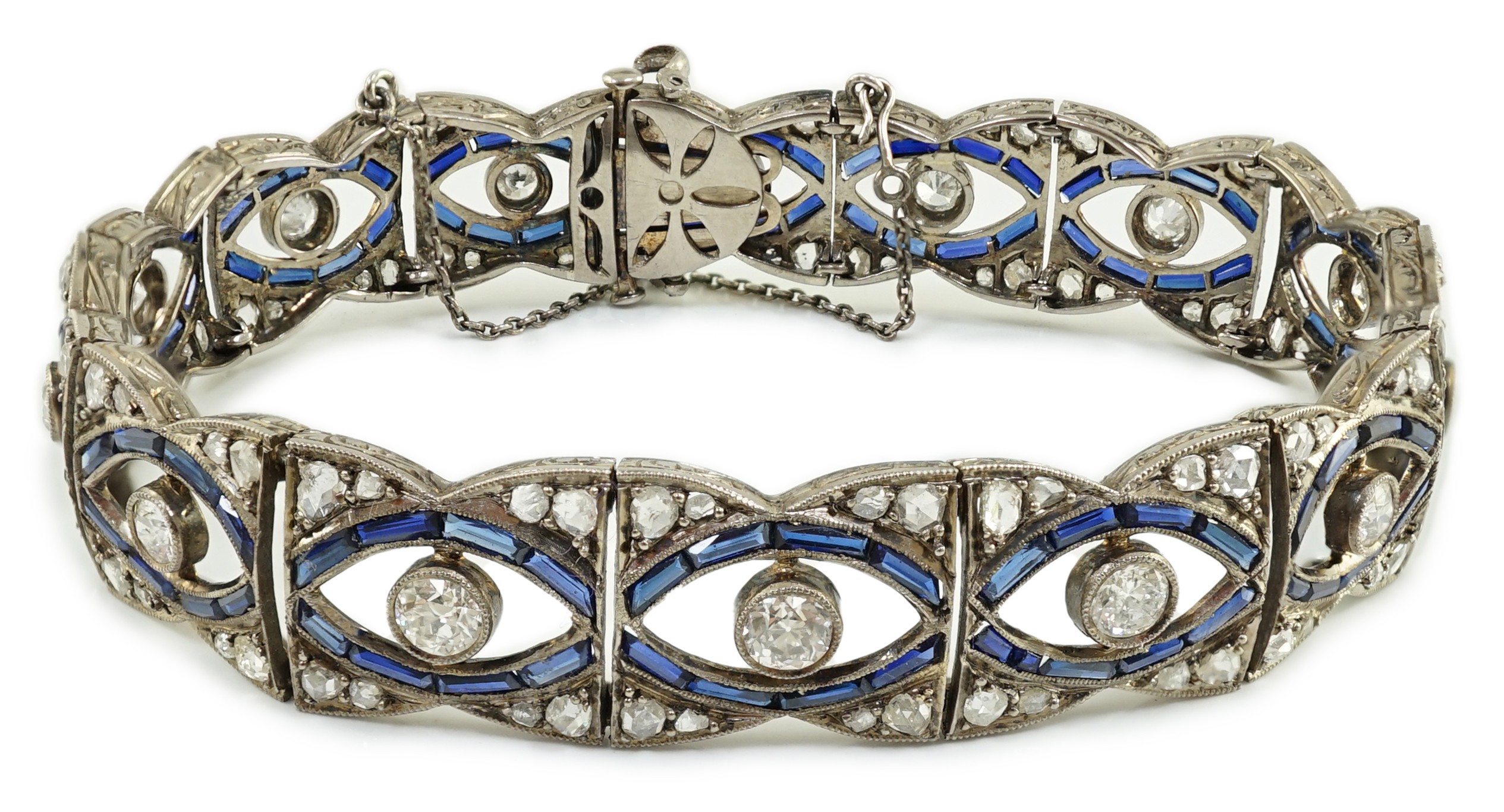 A 1920's 18ct white gold and millegrain set synthetic? sapphire and round and rose cut diamond set bracelet, with safety chain